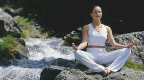 Yoga next to a wild river 