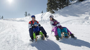 Family has fun tobogganing